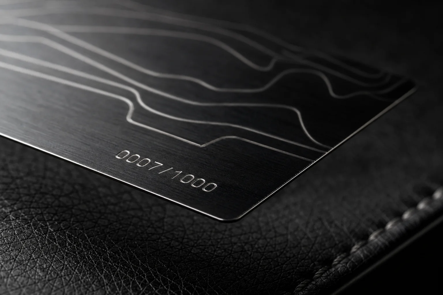 Fine silver laser engraving on a thin black PVD automotive member card