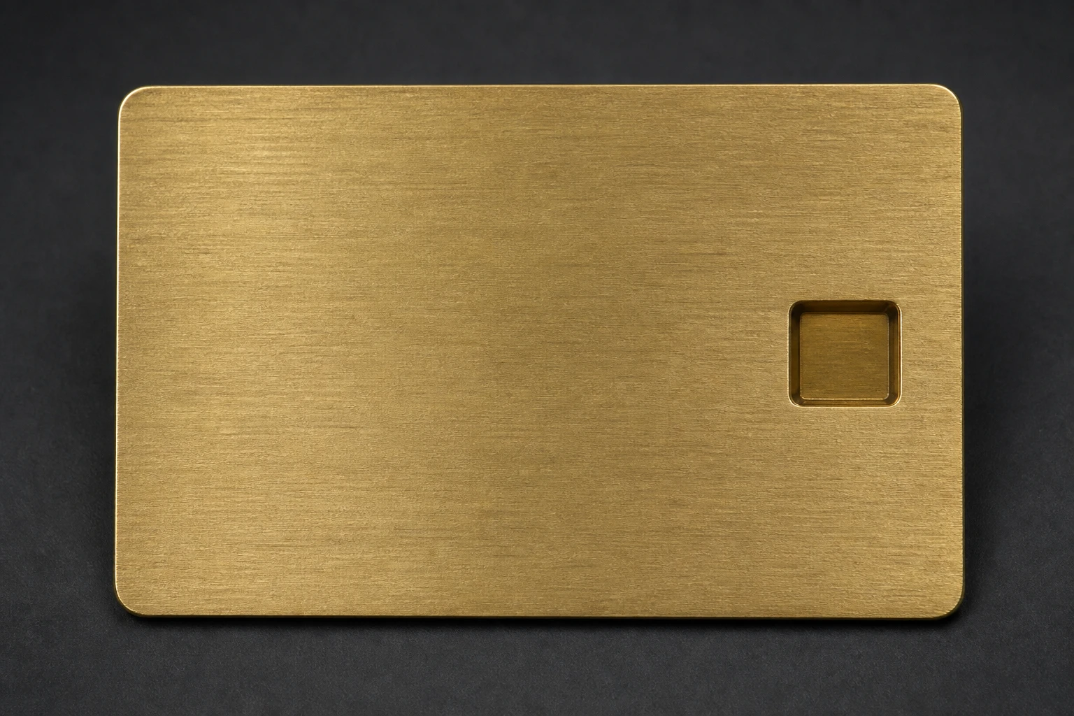 Brushed brass card with a controlled recessed mark