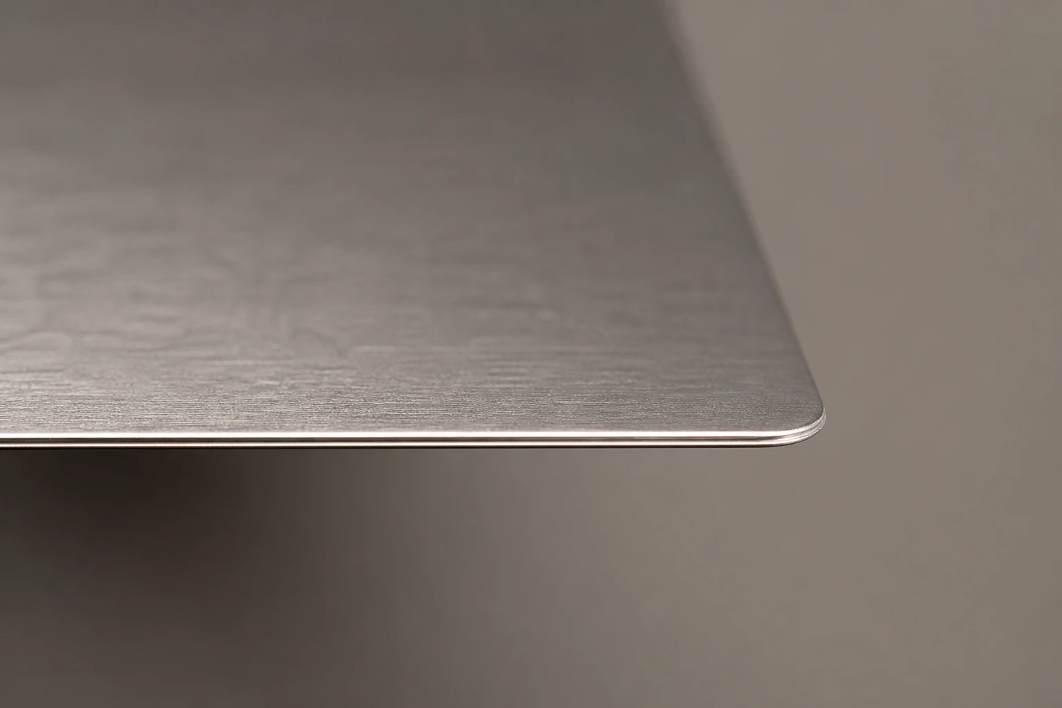 Brushed steel card with a deburred edge