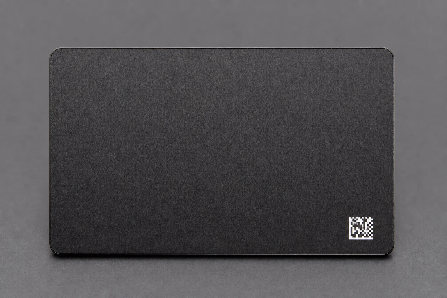 Sharp white data-matrix mark on black metal