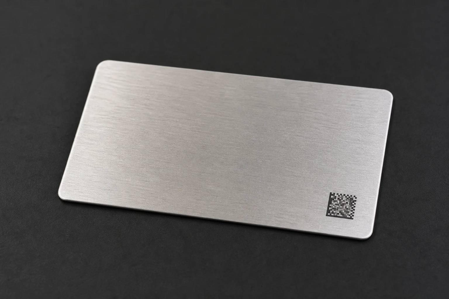 Brushed steel card with a discrete data-matrix mark