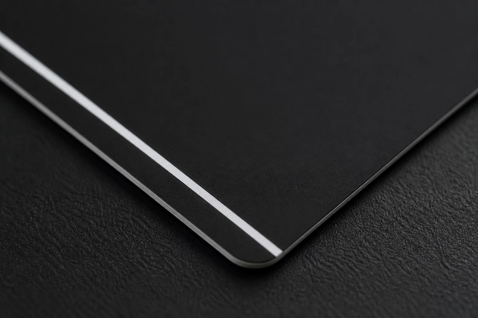 Thin white registration stripe on black metal